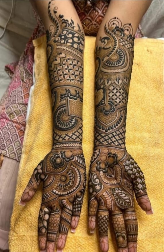 Full-arm bridal mehndi with jaali and mandala detailing