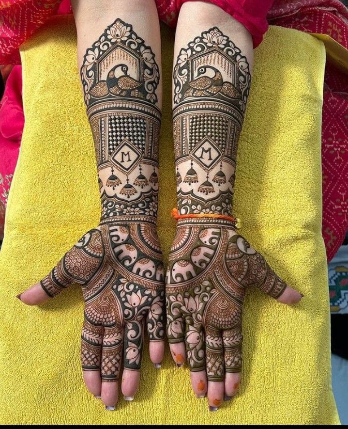 Bridal mehndi with peacock, initials and jhumka motifs