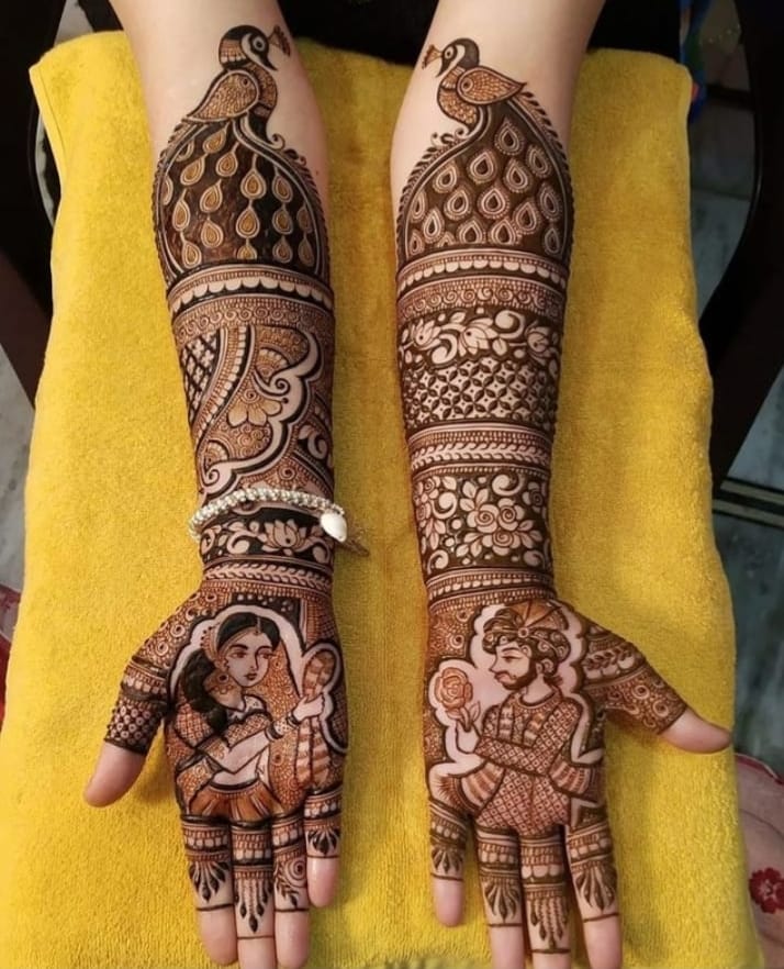 Bridal mehndi with peacock and dulha dulhan portrait motifs