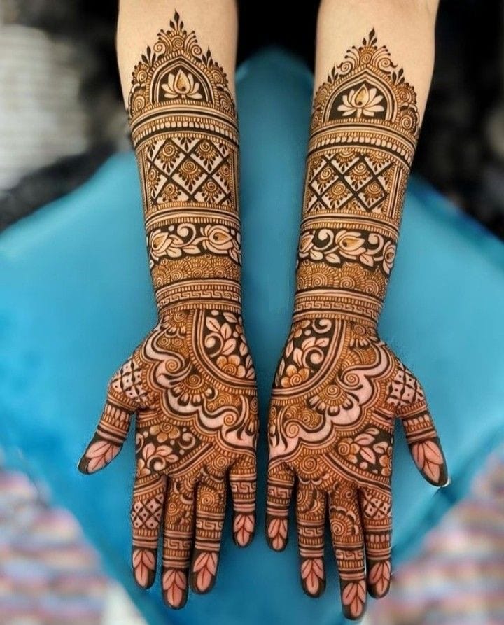 Traditional bridal mehndi with lotus temple motif on both arms
