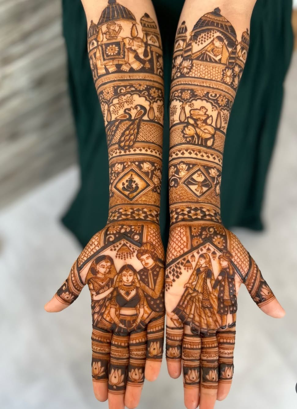 Bridal mehndi with peacock, Ganesha diamonds and family portrait palms