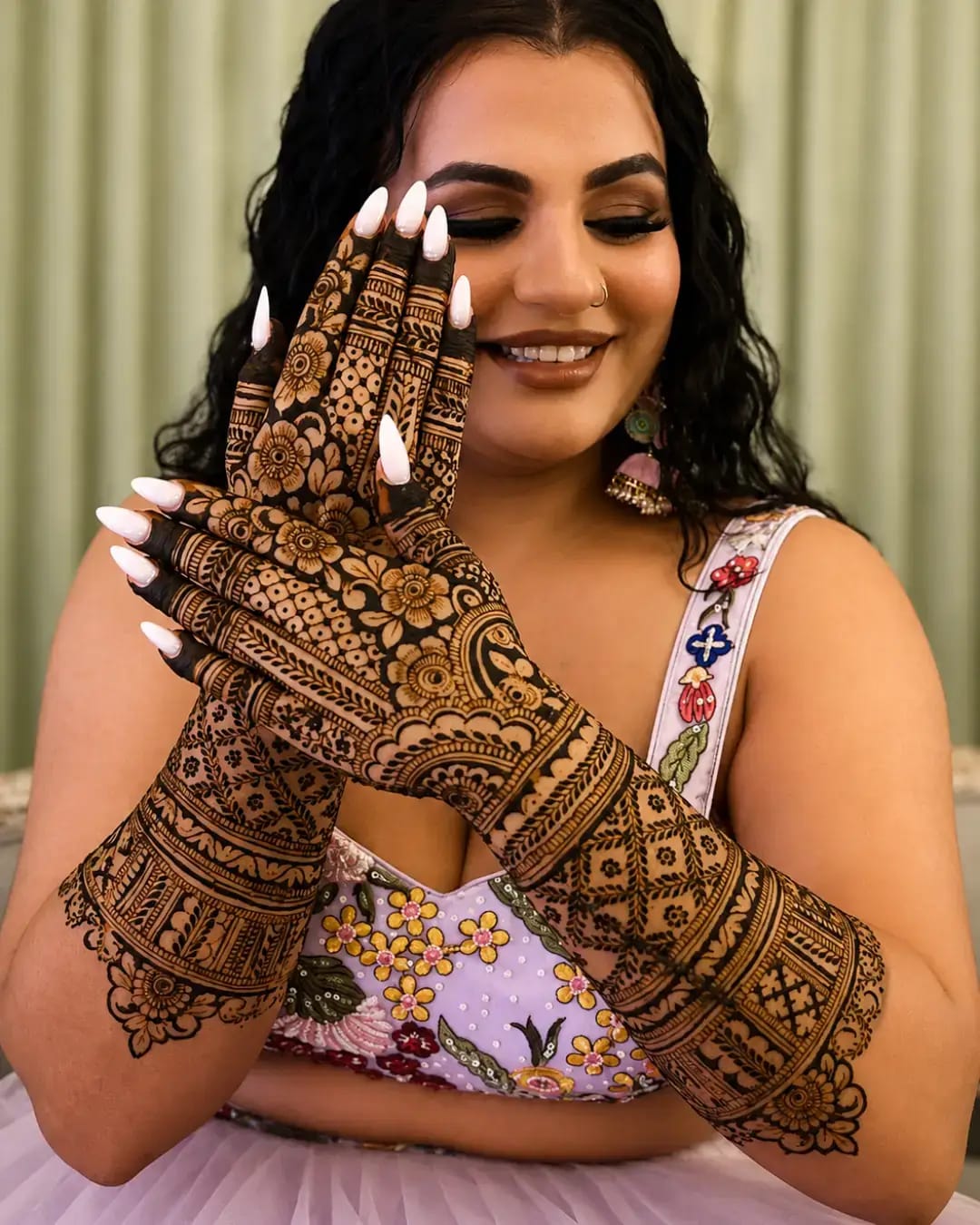 Dense floral mehndi on hands and forearms