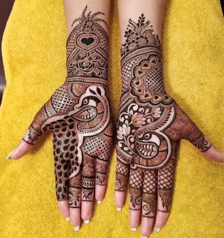 Bridal henna with peacock and heart motifs on palms