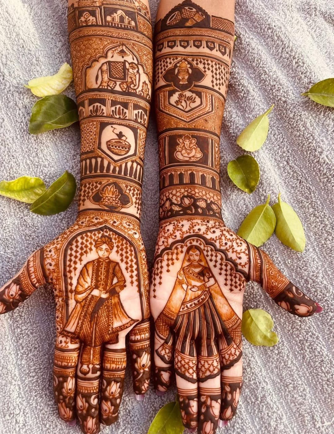 Rich stained bridal mehndi with elephants, Ganesha and dulha dulhan palms